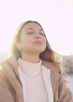 A serene individual practicing breathwork meditation, eyes closed, with glowing energy waves symbolizing deep relaxation, healing, and life force activation.