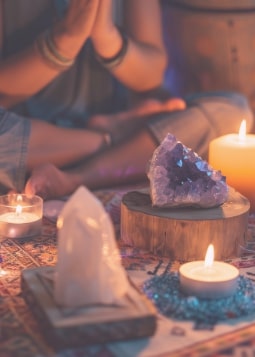 A peaceful individual meditating in a glowing aura, surrounded by cosmic energy and symbols of abundance, representing manifestation and spiritual alignment.